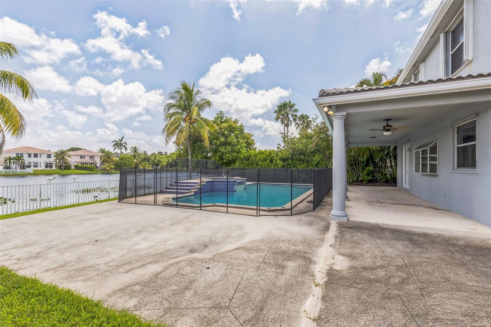 18091 Southwest 22nd Street Miramar, FL 33029 - Photo 37 of 41 a view of a house with a swimming pool and a yard