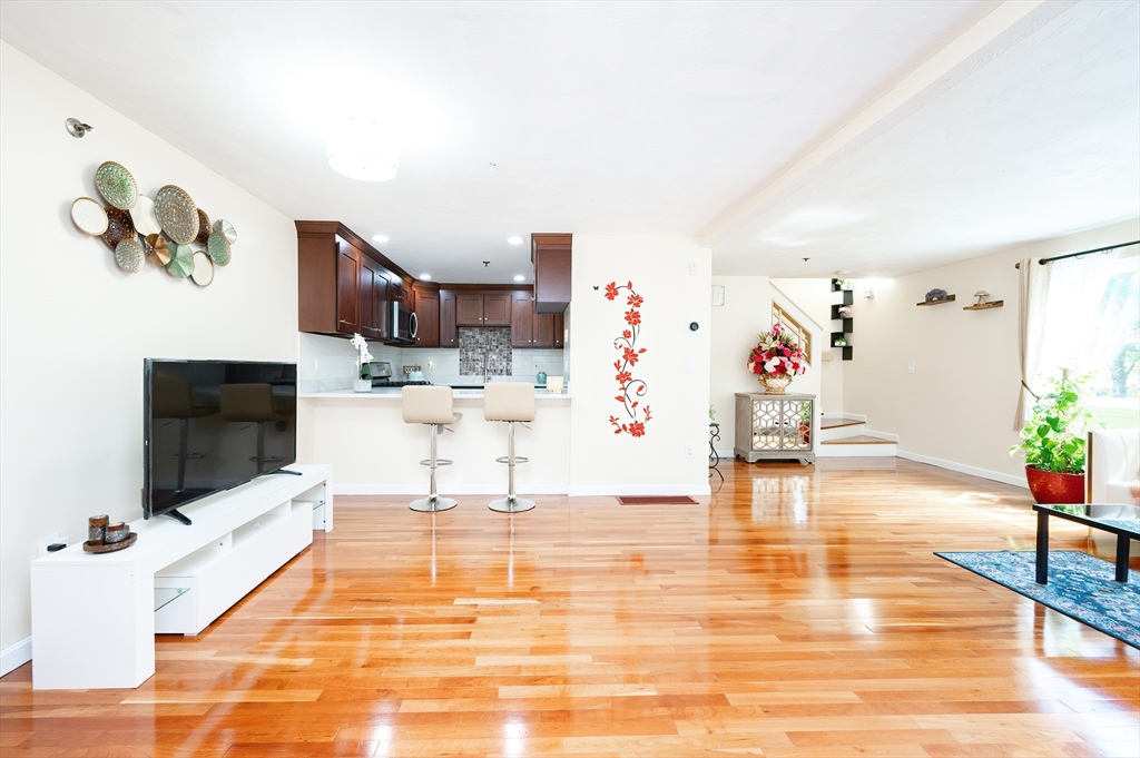 175 Littleton Road, Unit B20 Chelmsford, MA 01824 - Photo 1 of 35 a living room with furniture and a flat screen tv