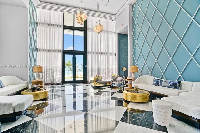 a living room filled with furniture and floor to ceiling windows