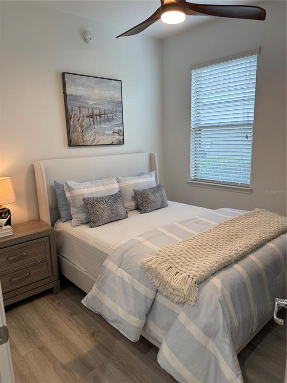 9122 Southwest 70th Loop Ocala, FL 34481 - Photo 11 of 31 a bedroom with a bed and a painting on the wall