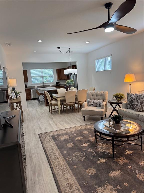 9122 Southwest 70th Loop Ocala, FL 34481 - Photo 13 of 31 a living room with furniture and a wooden floor
