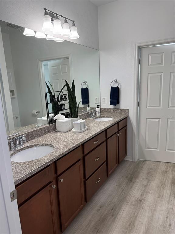 9122 Southwest 70th Loop Ocala, FL 34481 - Photo 17 of 31 a bathroom with a granite countertop double vanity sink and a mirror