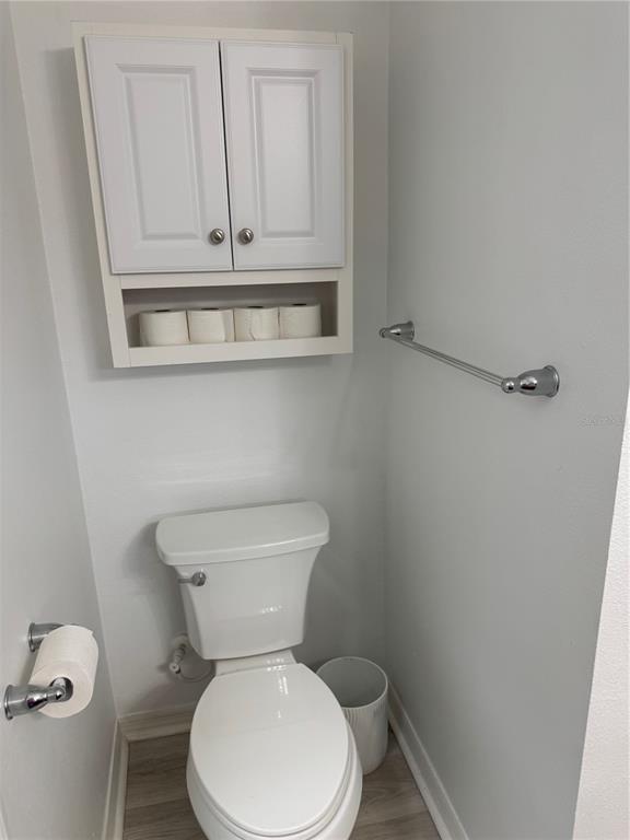 9122 Southwest 70th Loop Ocala, FL 34481 - Photo 19 of 31 a white toilet sitting next to a sink