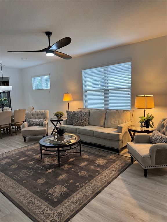 9122 Southwest 70th Loop Ocala, FL 34481 - Photo 2 of 31 a living room with furniture and a lamp