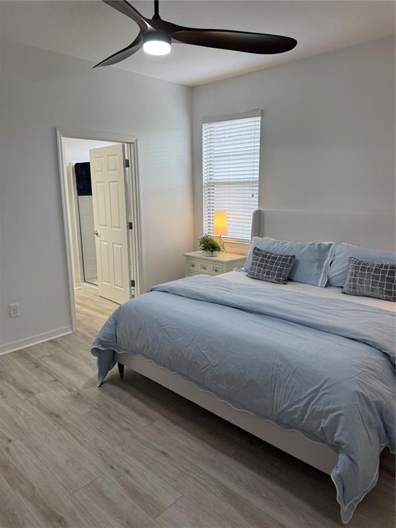 9122 Southwest 70th Loop Ocala, FL 34481 - Photo 22 of 31 a bedroom with a bed and a window