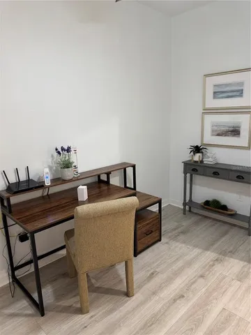a room with a table chairs and a wooden floor