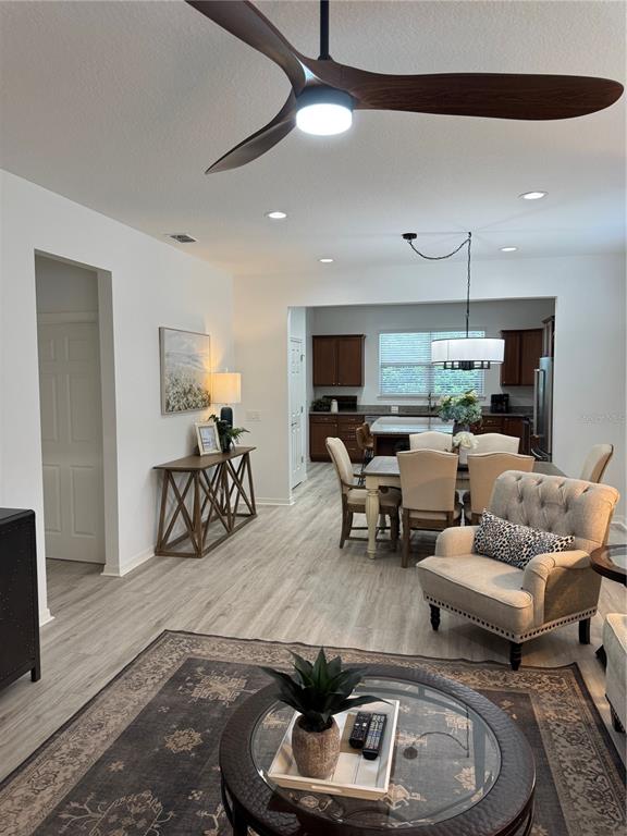 9122 Southwest 70th Loop Ocala, FL 34481 - Photo 27 of 31 a living room with furniture and a chandelier