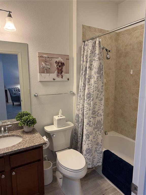 9122 Southwest 70th Loop Ocala, FL 34481 - Photo 3 of 31 a bathroom with a granite countertop sink toilet and shower