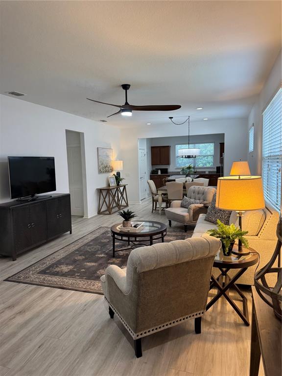 9122 Southwest 70th Loop Ocala, FL 34481 - Photo 6 of 31 a living room with furniture and a flat screen tv