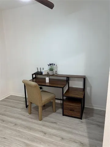 a dining room with furniture and wooden floor