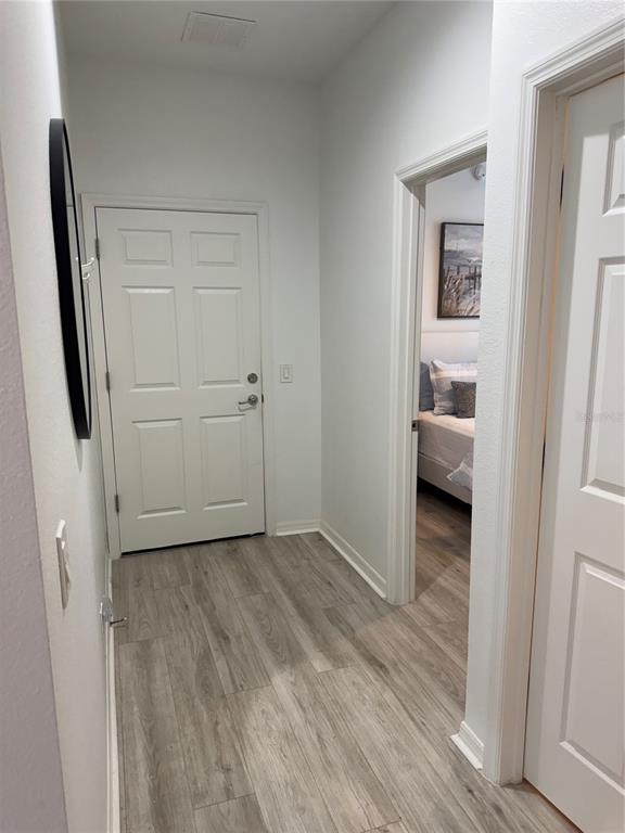 9122 Southwest 70th Loop Ocala, FL 34481 - Photo 10 of 31 a view of a hallway with wooden floor and closet