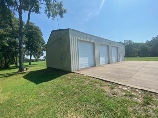 256 Shepherd Hollow Road Indian Mound, TN 37079 - Photo 13 of 29 a backyard of a house with plants and trees