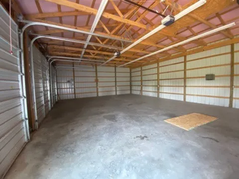 a view of empty room with wooden walls