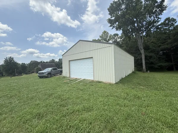 a view of a house with a backyard