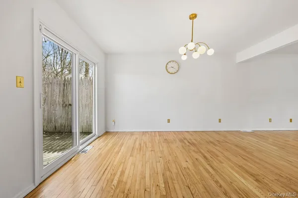 a view of a room with wooden floor and window
