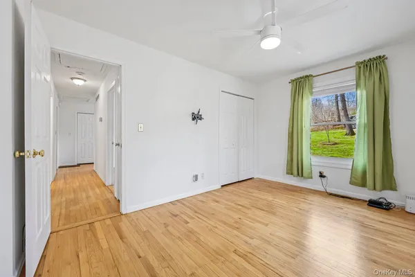 an empty room with closet and windows