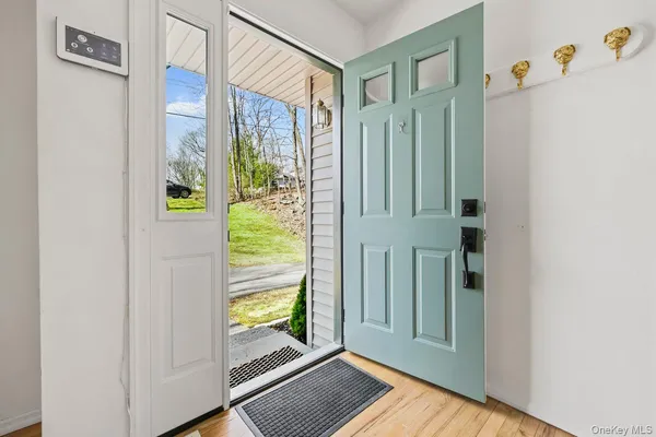 a view of front door with wooden floor