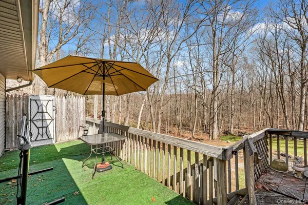 a view of a chair and table under an umbrella