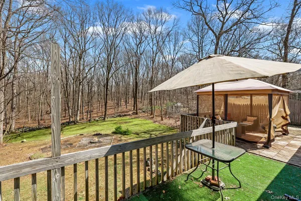 a view of a chair and table in the backyard