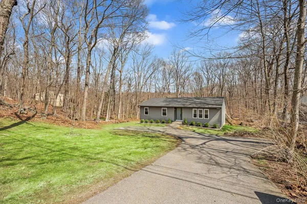 a front view of a house with a yard garage and outdoor seating