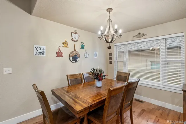 a view of a dining room with furniture and chandelier