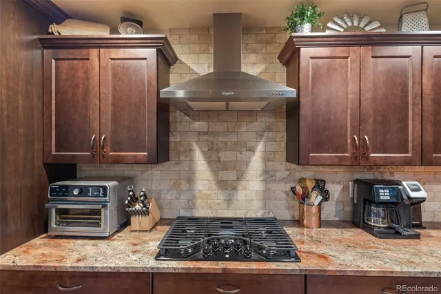 a kitchen with granite countertop a stove and a sink