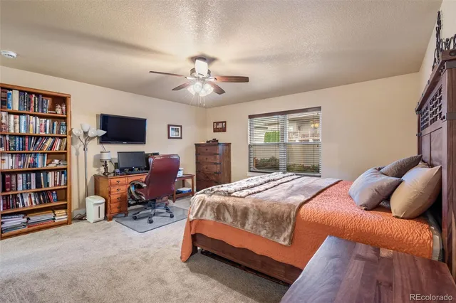 a bedroom with a bed furniture and a book shelf