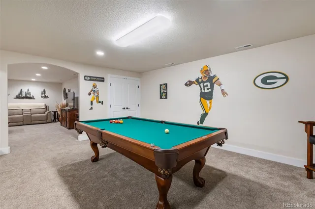 a room with furniture and pool table