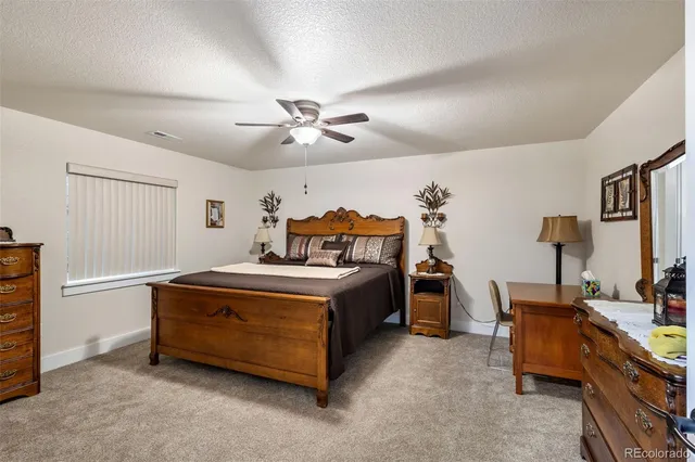 a bedroom that has a bed and a chandelier