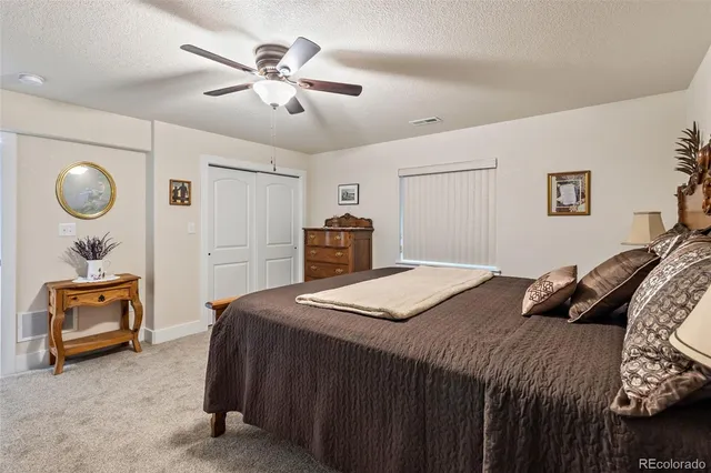a bedroom with a bed and dresser with mirror