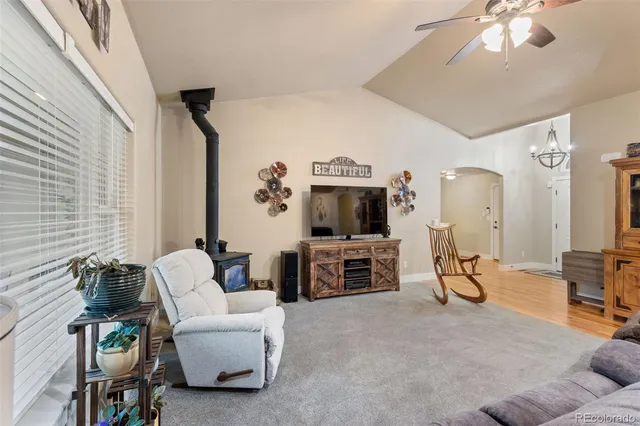 a living room with furniture a flat screen tv and gym equipment