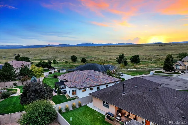 a front view of a house with a garden and yard