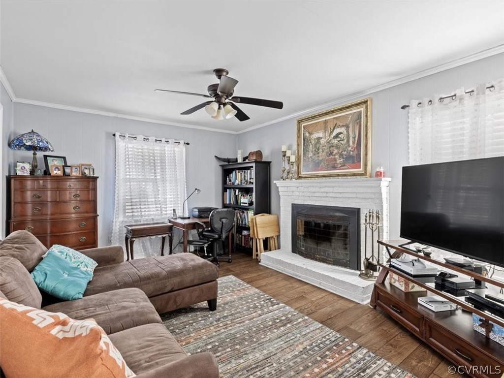 6710 West Road Chesterfield, VA 23832 - Photo 8 of 26 a living room with furniture a flat screen tv and a fireplace