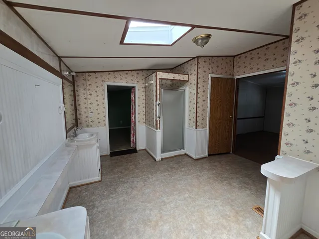 a kitchen with kitchen island granite countertop a sink stove and refrigerator