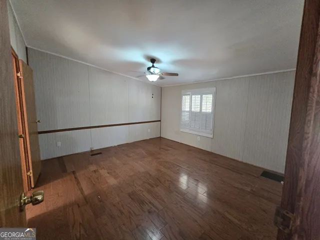 a view of a field of grass and trees