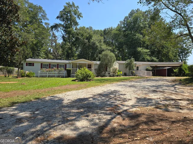 a kitchen with stainless steel appliances granite countertop a sink a stove a refrigerator cabinets and a dining table