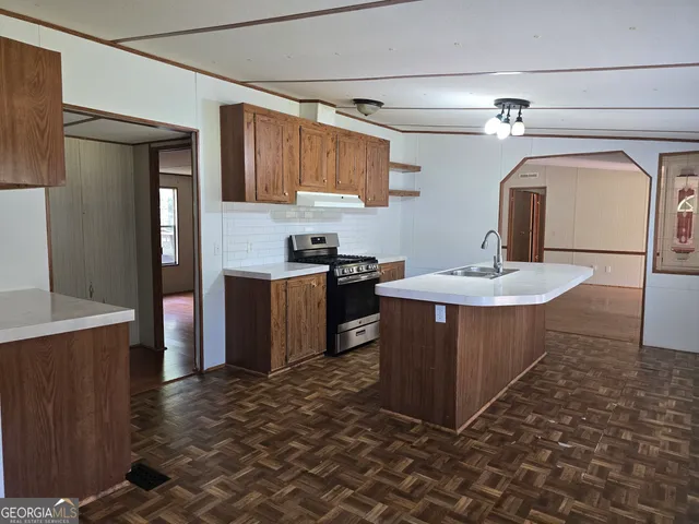 a kitchen with sink refrigerator and large window