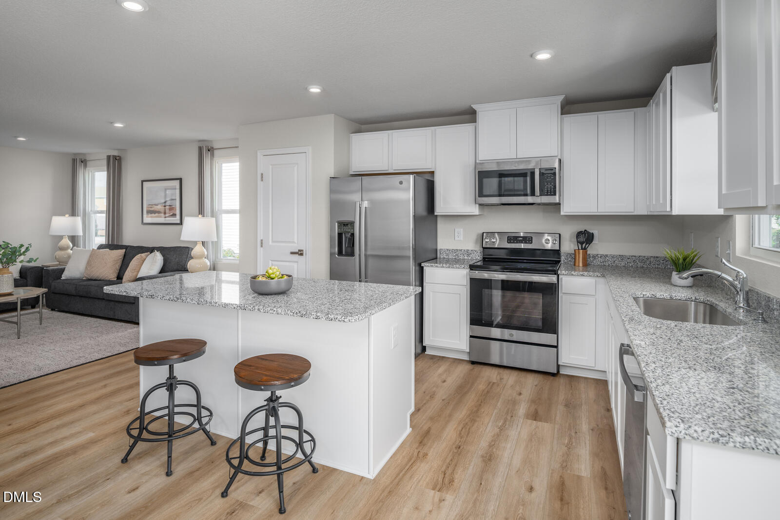 4070 Dragonfly Road Bailey, NC 27807 - Photo 2 of 20 a kitchen with stainless steel appliances granite countertop a stove top oven a refrigerator a sink and white cabinets with wooden floor