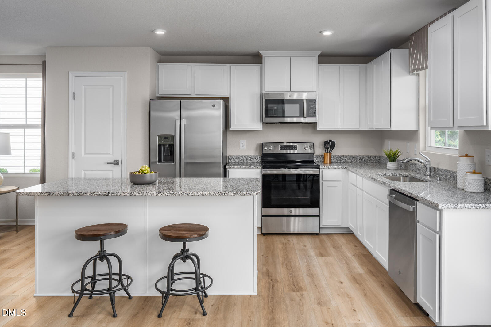 4070 Dragonfly Road Bailey, NC 27807 - Photo 4 of 20 a kitchen with stainless steel appliances granite countertop a stove top oven a sink a counter space and cabinets