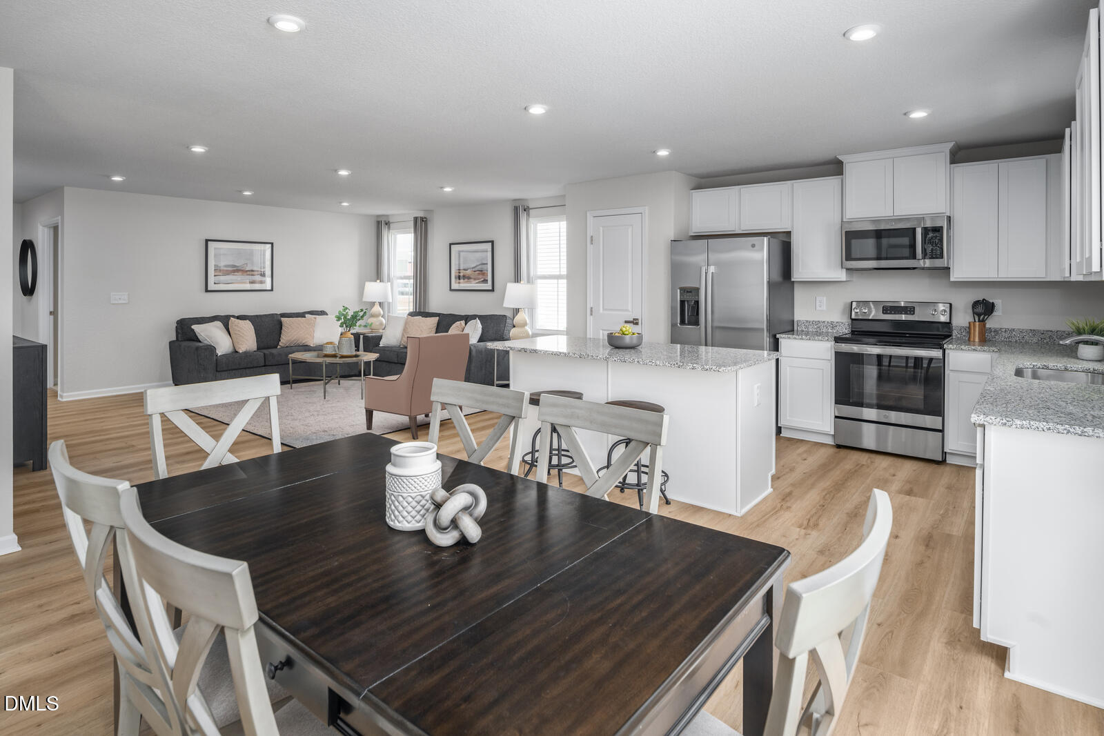 4070 Dragonfly Road Bailey, NC 27807 - Photo 6 of 20 a kitchen with stainless steel appliances granite countertop a stove a table and chairs