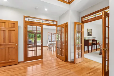a view of front door with wooden floor and windows