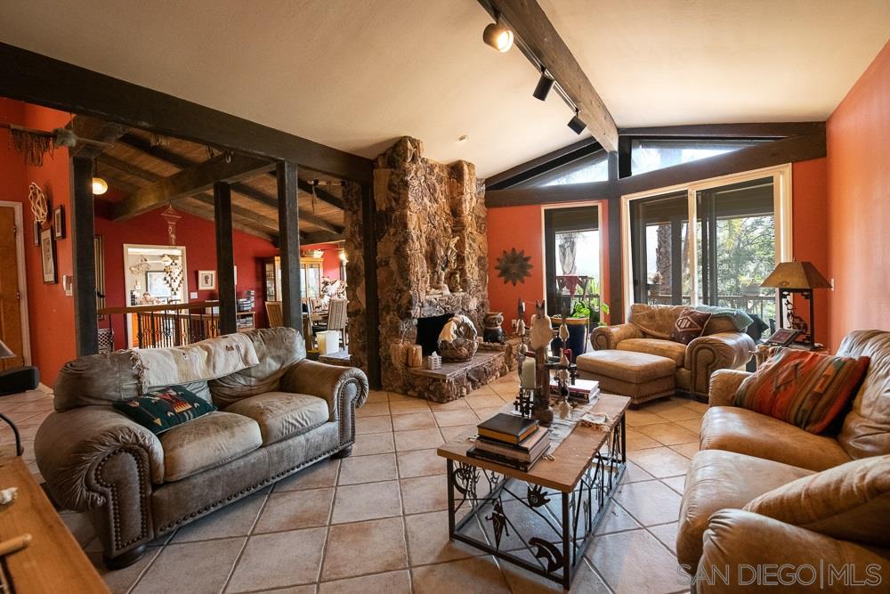 15330 Markar Road Poway, CA 92064 - Photo 6 of 24 The living room opens to the outdoor deck that spans across the back of the house to the master bedroom.
