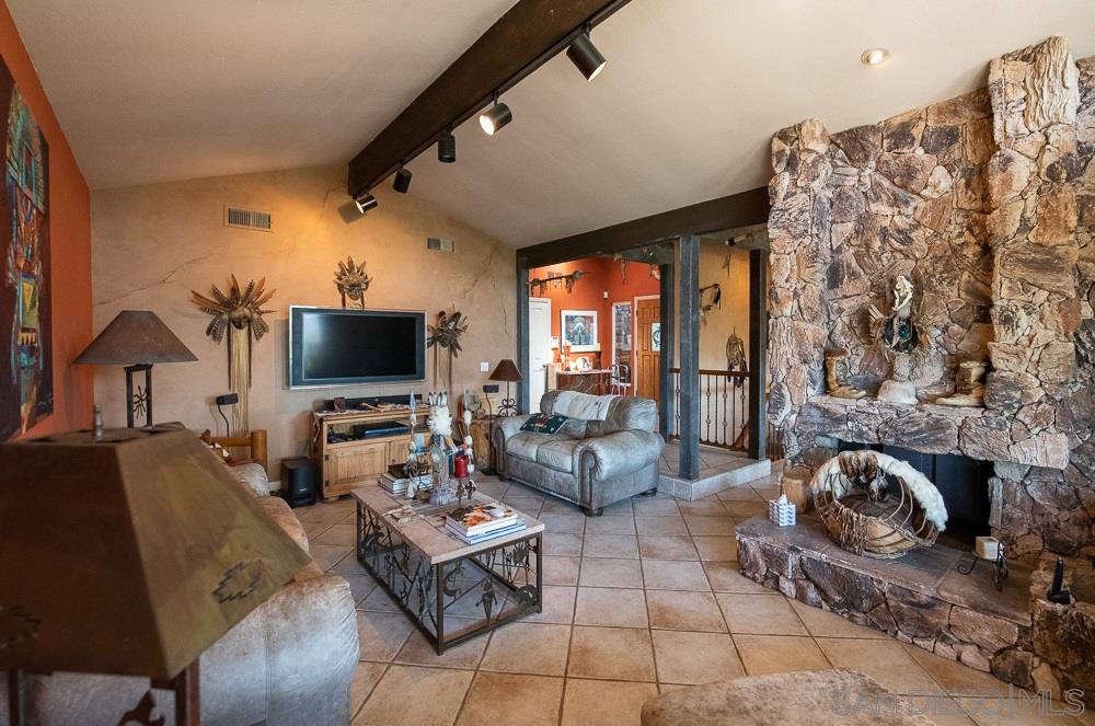 15330 Markar Road Poway, CA 92064 - Photo 8 of 24 The fireplace is dual sided and opens to the living room and dining room.