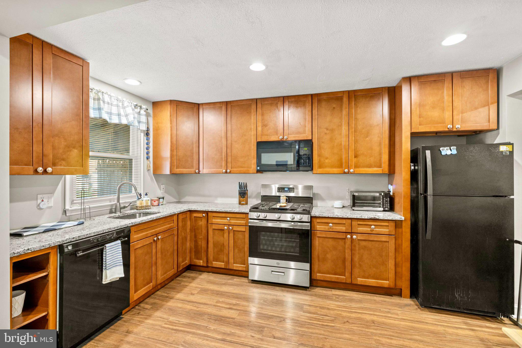 234 West Edgevale Road Baltimore, MD 21225 - Photo 1 of 45 Modern kitchen with warm wood tones.