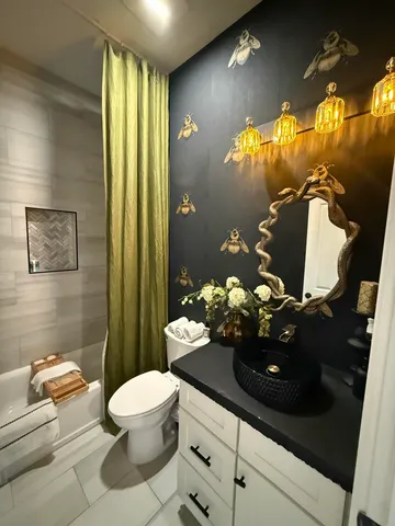 a bathroom with a sink toilet and shower