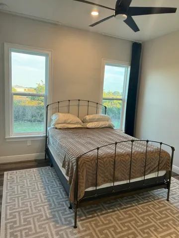 a bedroom with a bed and window