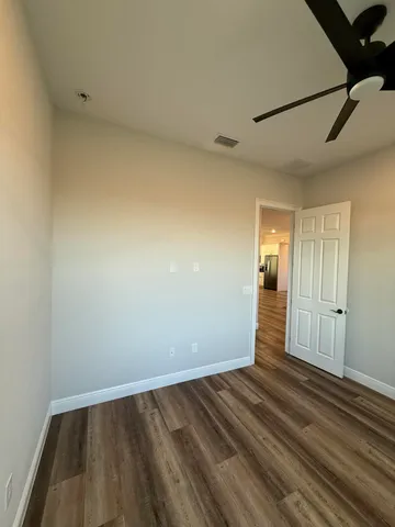 a view of wooden floor and windows in a room