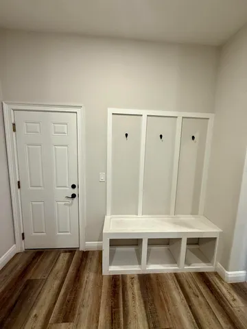 a view of an empty room with wooden floor