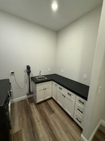 a view of a kitchen with wooden floor
