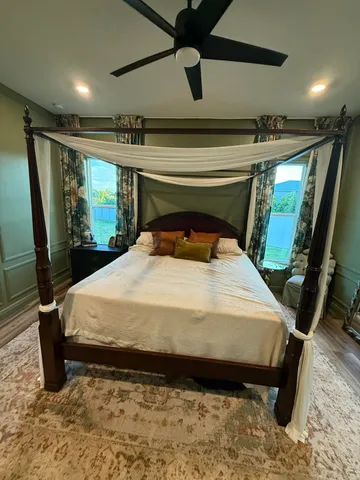 a bed sitting in a room next to a window